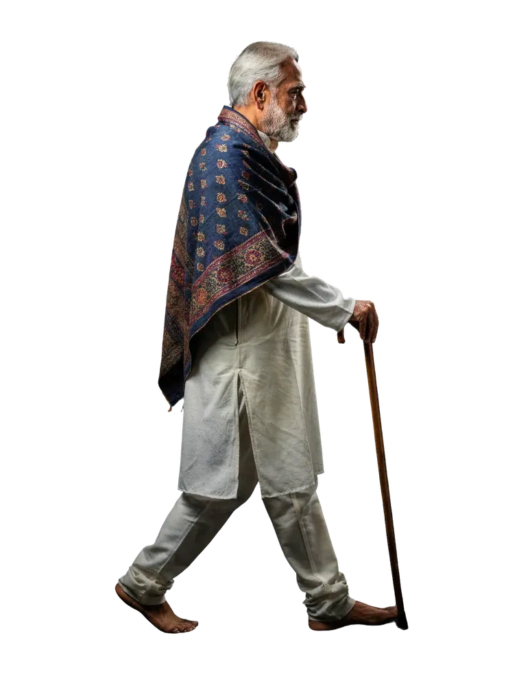 Older man standing with a walking stick